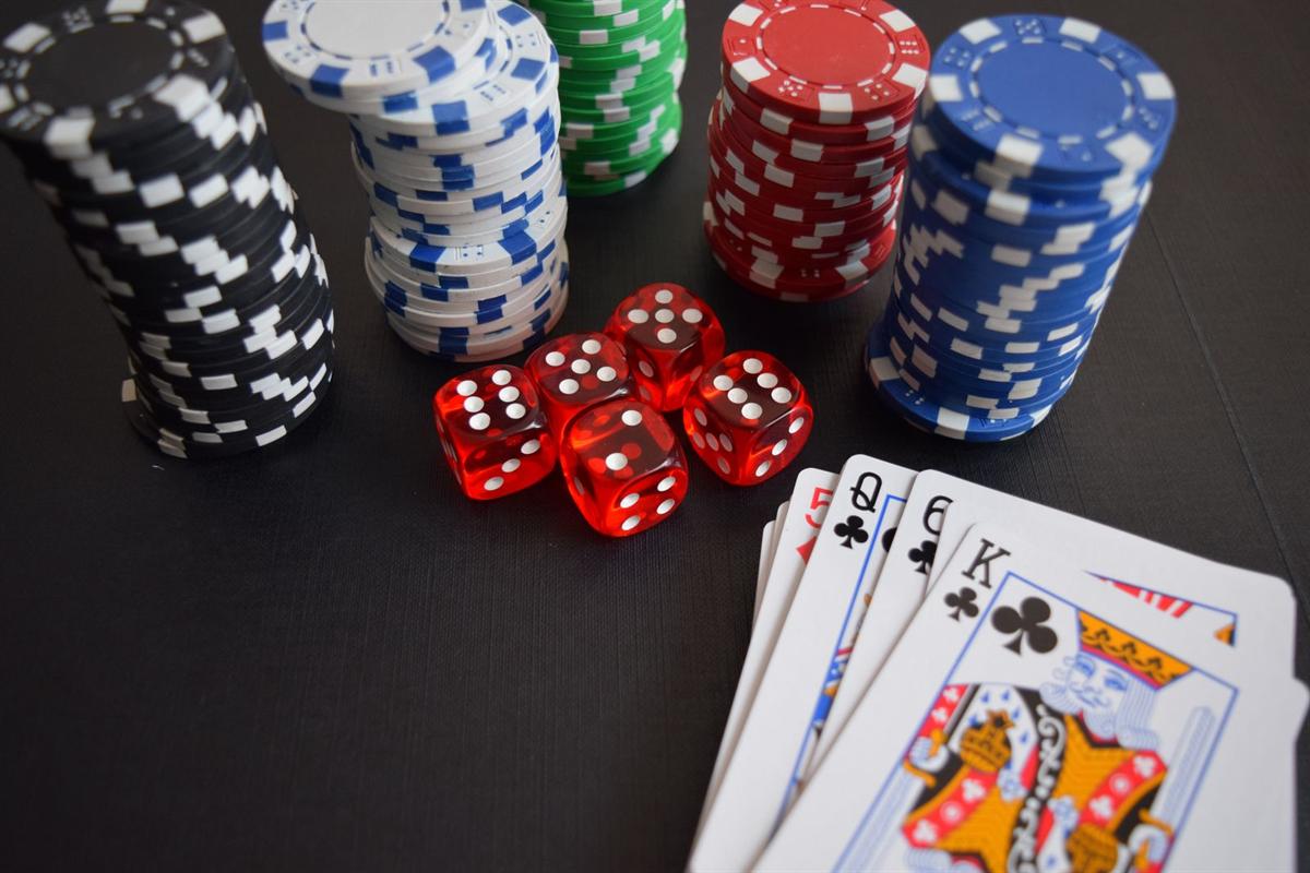 Chip poker, dadu, dan kartu permainan tersusun di atas meja